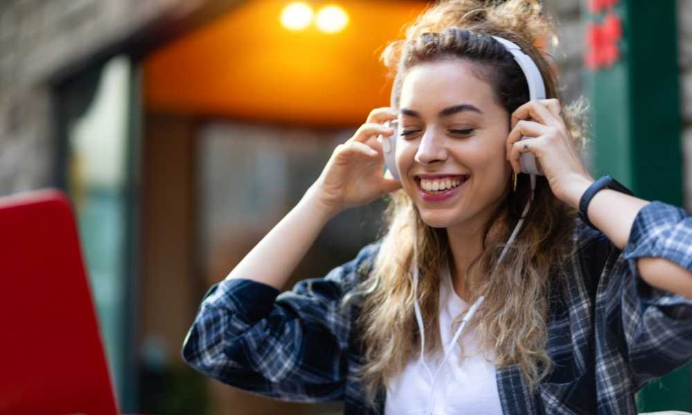 Girl with Headphones outside studying